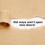 Inspirational quote Old Ways Will Not Open New Doors typed on vintage typewriter.